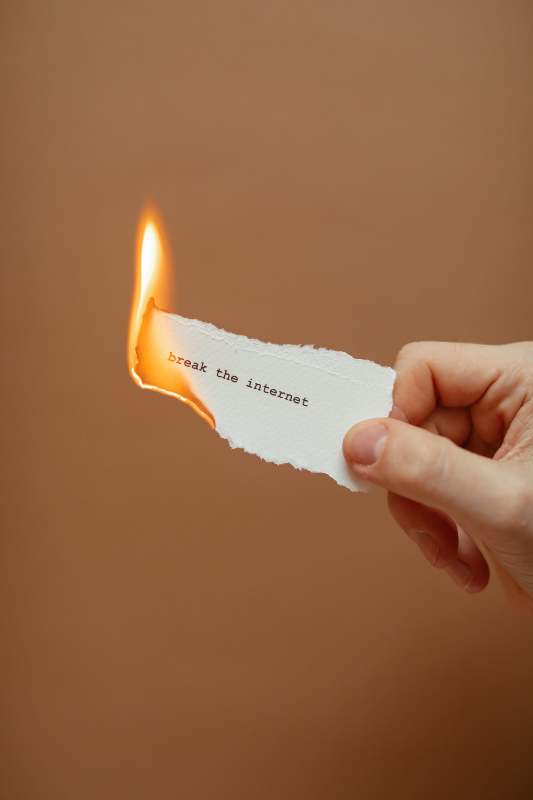 A slip of paper burning at one edge